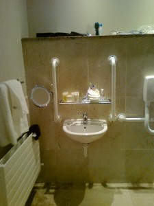 Tiny basin with glass shelf in the way. Do disabled people need tiny basins?