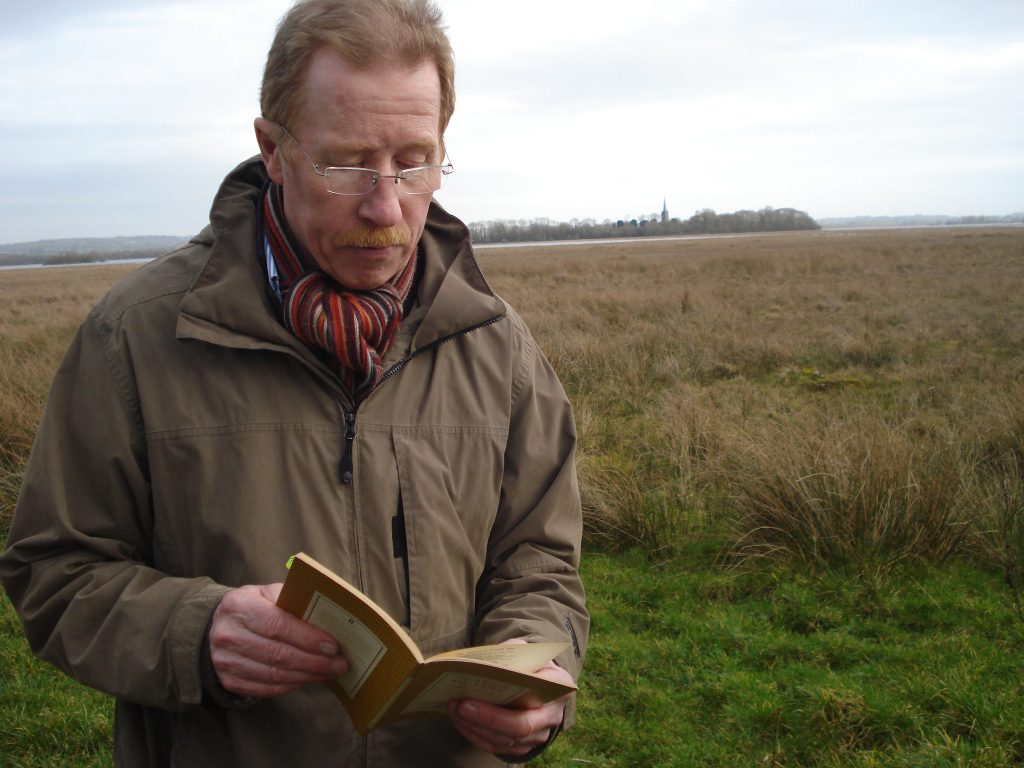 Eugene Kielt of Laurel Villa Guest House reading on The Strand at Lough Beg - Eugene is a Blue Badge guide and expert in Seamus Heaney's poetry.
